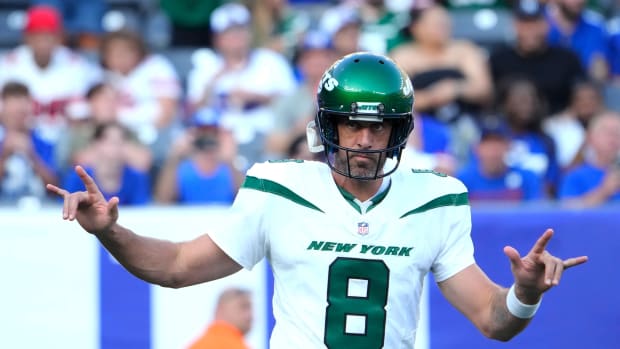 Jets' QB Aaron Rodgers (8) shows love for the crowd